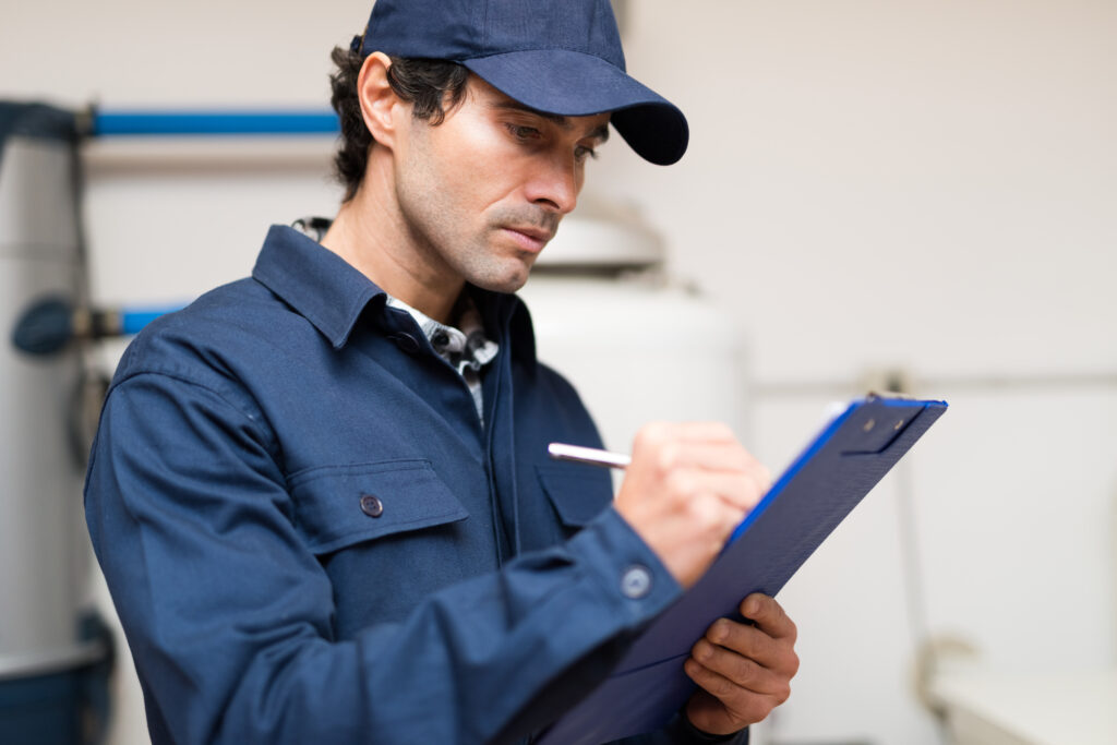Maintenance worker taking notes