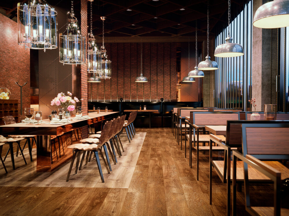 Restaurant élégant d’hôtel avec décoration moderne, éclairage chaleureux et tables dressées.