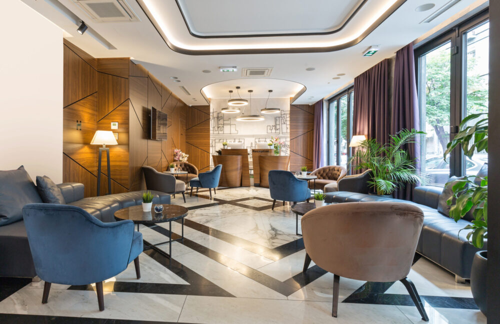 A contemporary hotel lobby with a bright reception area and elegant furnishings.
